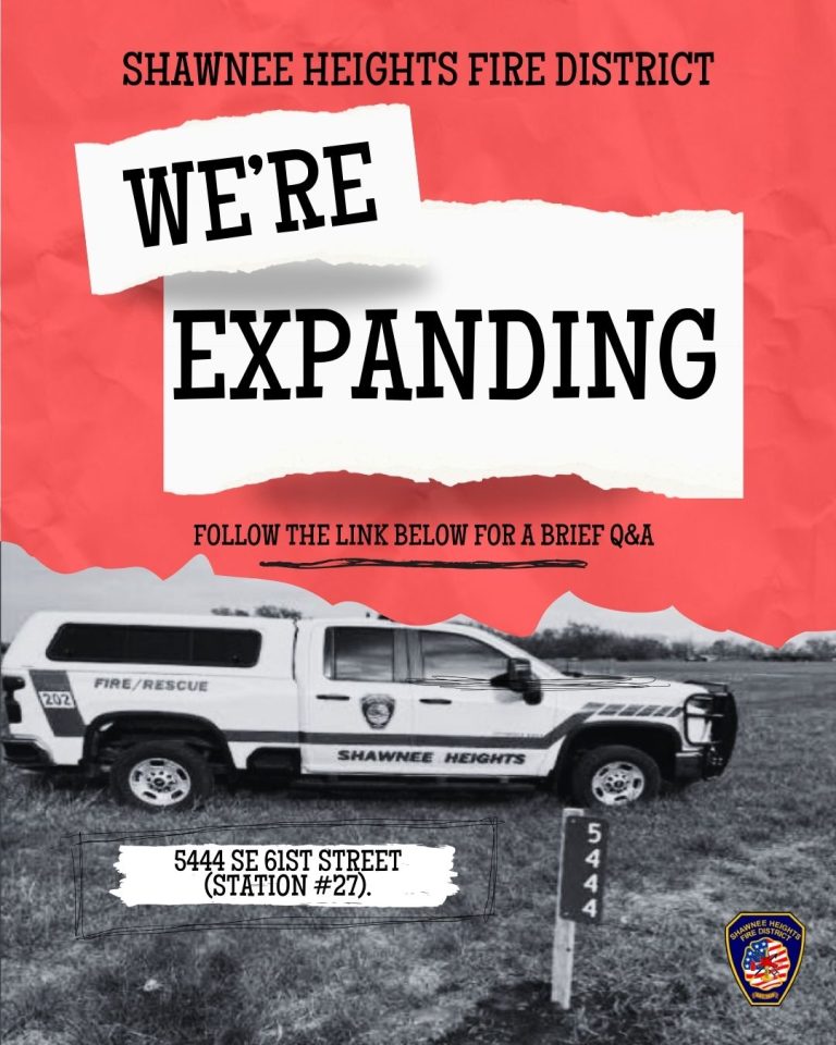 A Shawnee Heights Fire District truck is parked on grass near a sign labeled "5444." Text above the truck says "We're Expanding" and gives the address 5444 SE 61st Street (Station #27) with a Q&A link.